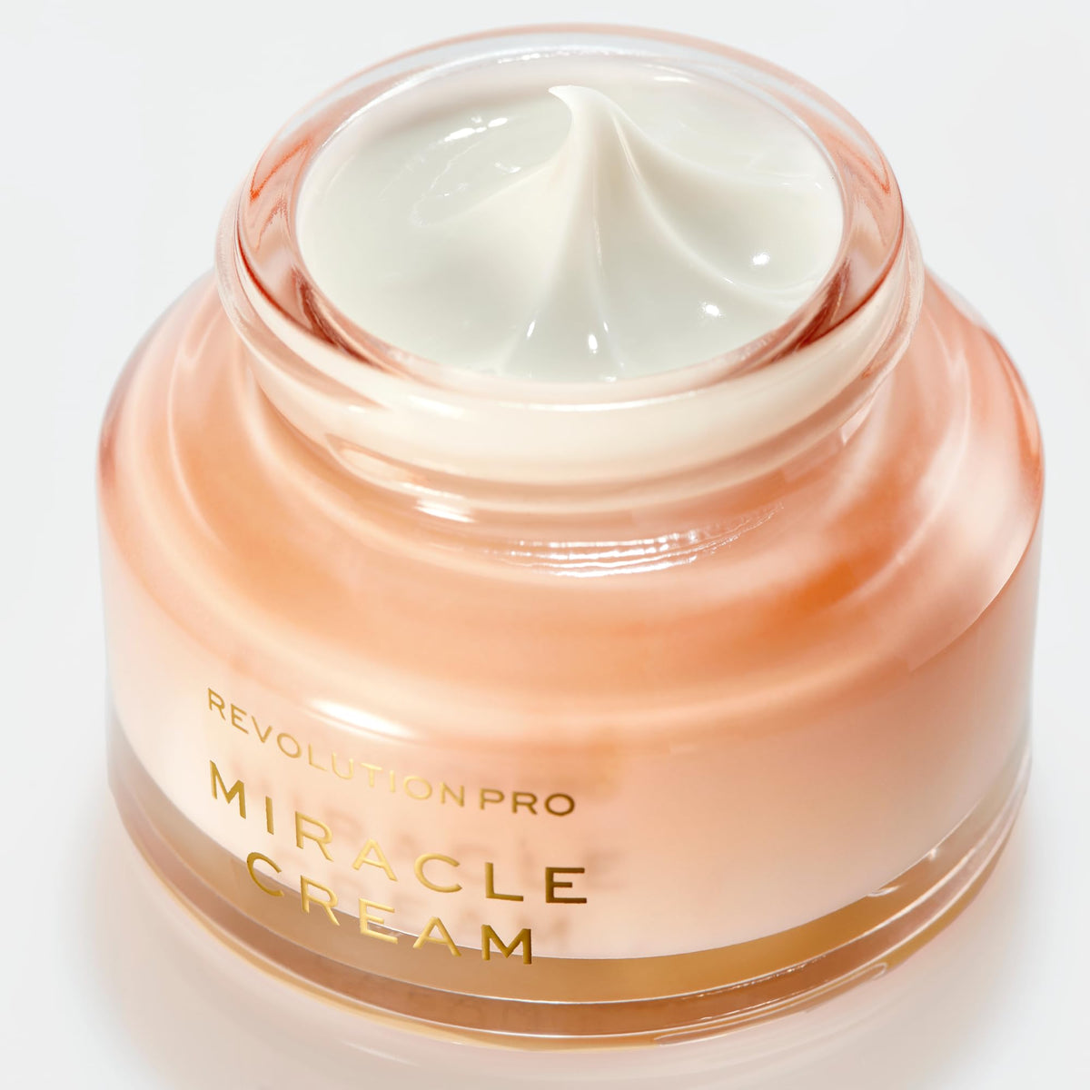 Revolution Beauty London cream being applied to hand, demonstrates fast absorption and plumpness