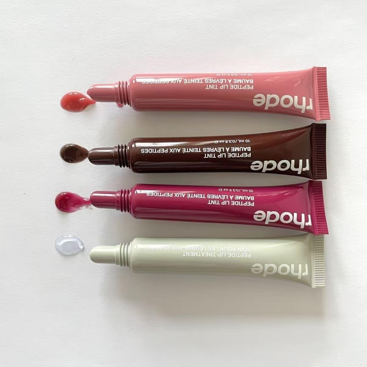 Rhode worn on lips in lifestyle shot showcasing natural glossy sheen