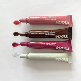 Rhode worn on lips in lifestyle shot showcasing natural glossy sheen