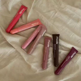 Rhode swatch on arm revealing sheer buildable Toast color payoff