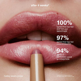 Model applying Rhode Peptide Lip Shape Press demonstrating natural, well-defined lip contour benefit