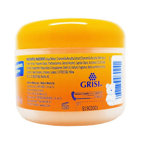 Ricitos de Oro bottle in adult hand showing compact 4.05 oz travel-friendly size