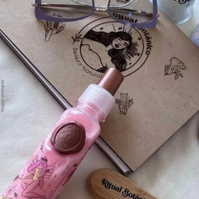 Ritual Botanico model spraying product on dry hair to refresh fragrance