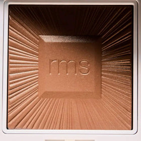 RMS Beauty hydra bronzer being applied with brush for seamless contouring