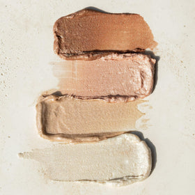 RMS Beauty luminizer lightly applied to collarbones for natural body radiance