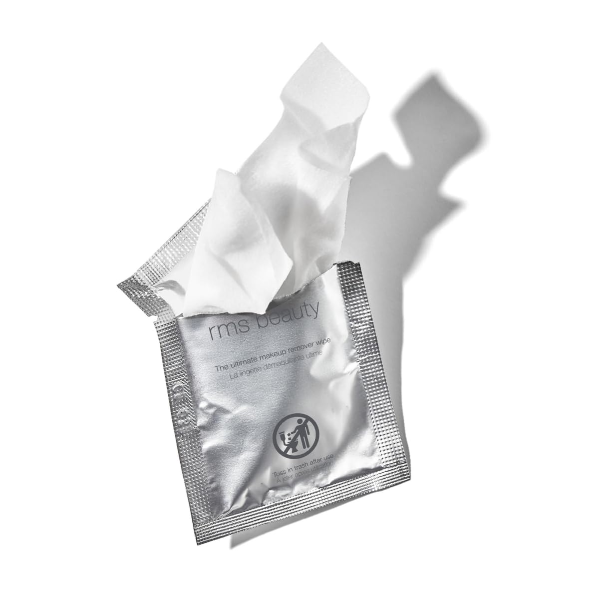 RMS Beauty wipe held in hand for size comparison and easy single-use convenience