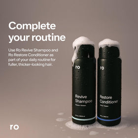 Shampoo lather on hand in shower, Ro demonstrating effective buildup removal benefit