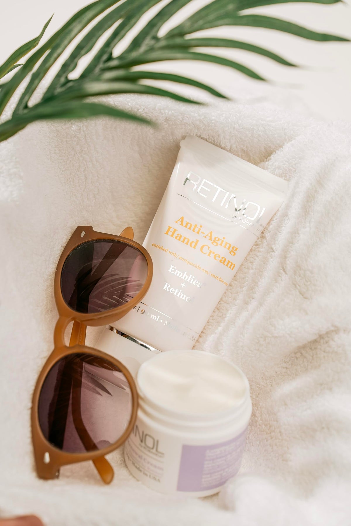 Robanda tube in a purse setting showing portability and on-the-go skin renewal