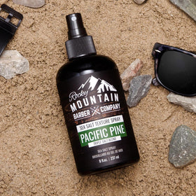 Rocky Mountain Barber Company bottle held in hand showing 8 oz scale