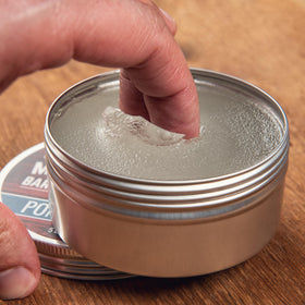 Rocky Mountain Barber Company tin next to ruler showing 5 oz scale and long-lasting value