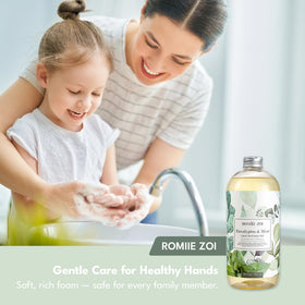 ROMIIE ZOI 750 ml bottle beside a hand to show scale and large refill capacity