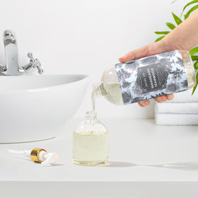 ROMIIE ZOI bottle staged in a kitchen showing grease-cutting effectiveness