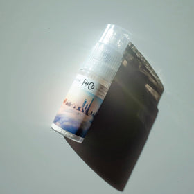 Applying R+Co powder to roots to refresh oily hair and create instant lift