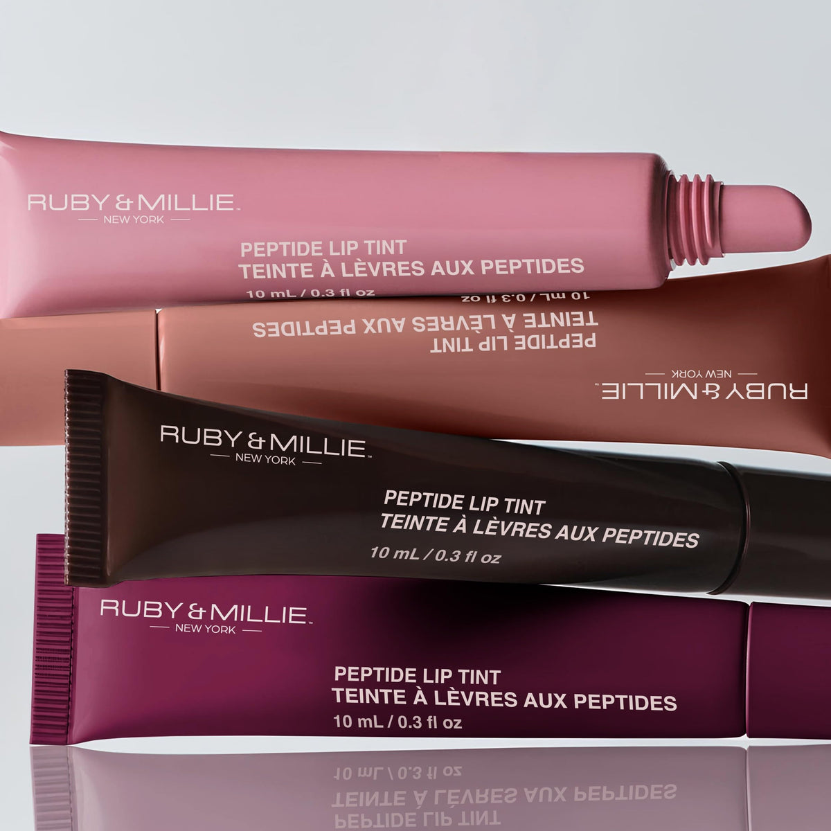 Ruby & Millie tube in hand demonstrating compact travel size and easy portability