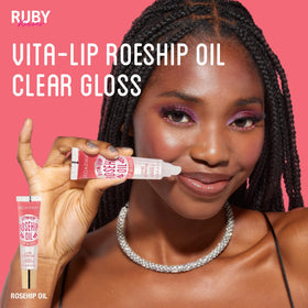 Ruby Kisses gloss in hand showing size and travel-friendly scale