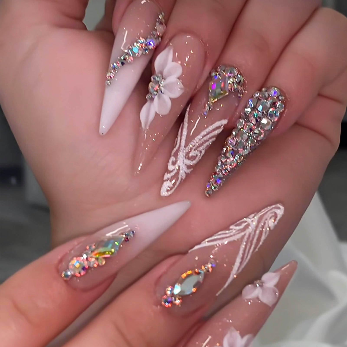 RUOKEXIN rhinestone detail on white ombré nail showcasing sparkle and refined accent
