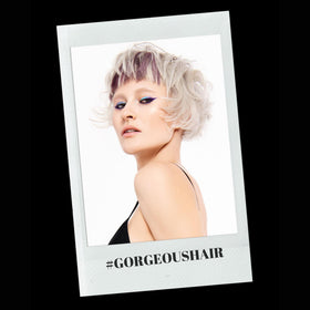 RUSK mousse being applied during blow-dry for added volume and toned color