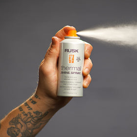 RUSK spray in use during blow-dry demonstrating heat protection and frizz control