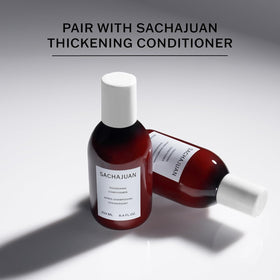 SACHAJUAN 8.4 oz bottle beside hand for size and travel-friendly benefit