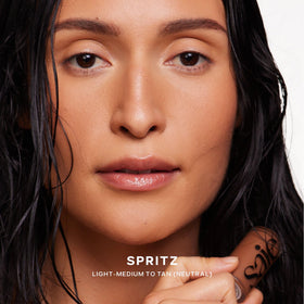 Saie Dew Bronze applied to cheekbone demonstrating sun-kissed highlight and natural warmth