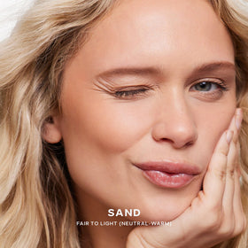 Saie Dew Bronze applied on model cheek illustrating natural sun-kissed glow and subtle sculpting