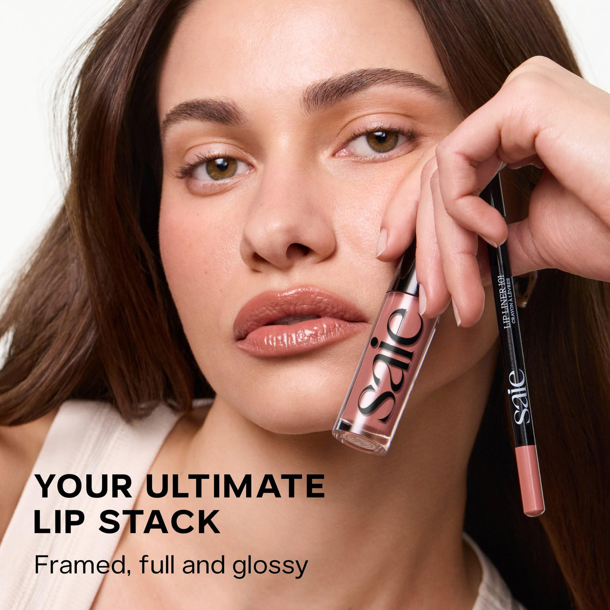 Saie Glossybounce next to a ruler showing .17 oz compact size for travel