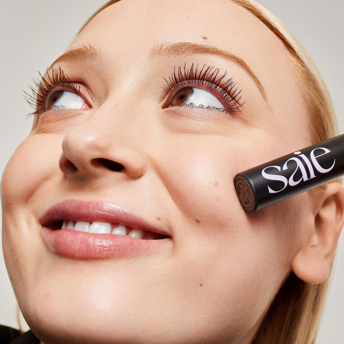 Saie tube next to coin for size and travel-friendly convenience