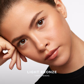 Saie Sun Melt blended on model cheek for natural sun-kissed warmth benefit