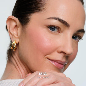 Saie brush applying blush on skin showing seamless blend benefit