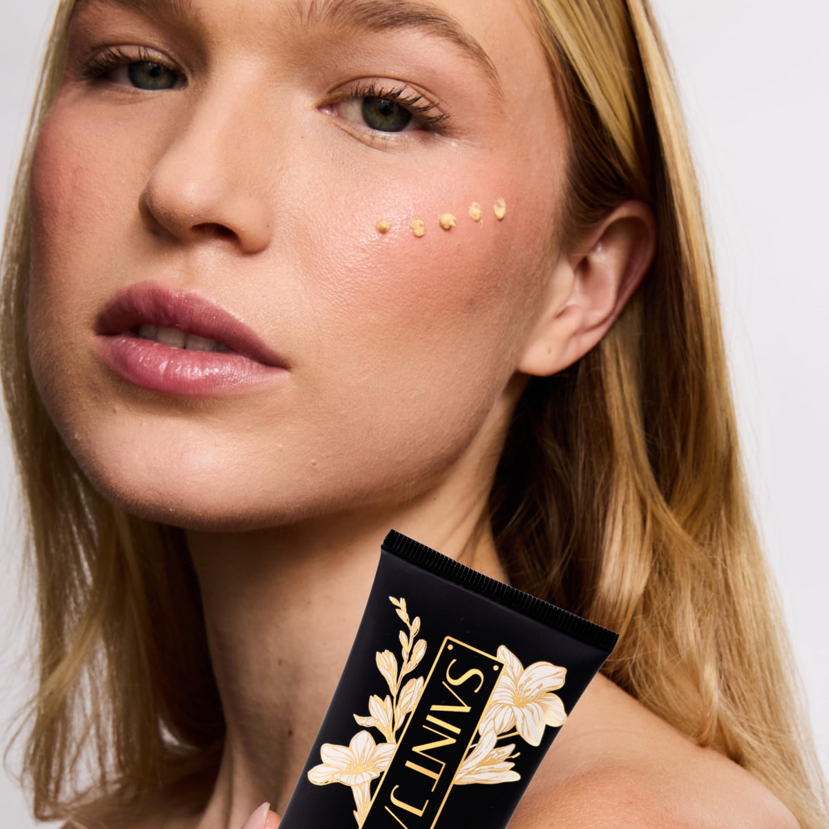 SAINT JANE product with floral accents illustrating luxe botanical formula