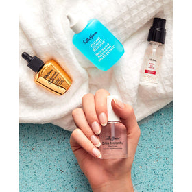 Lifestyle shot of hands using Sally Hansen serum with smooth cuticles and polished look