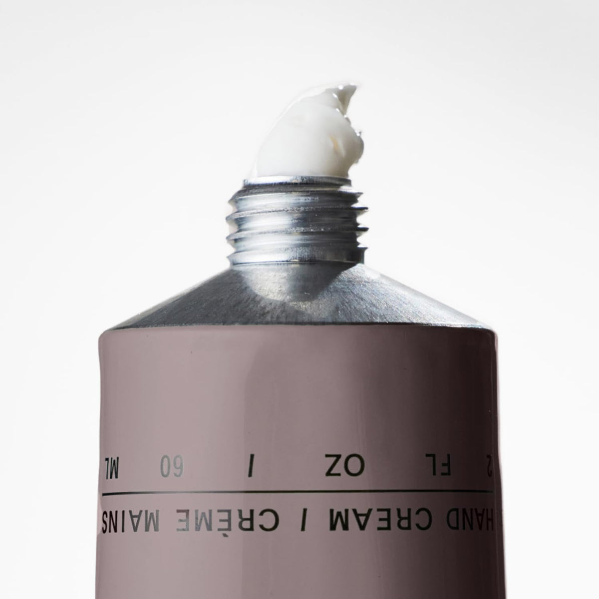 Salt & Stone tube on vanity with candle showing unisex fragrance lifestyle appeal