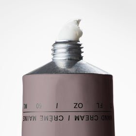 Salt & Stone tube on vanity with candle showing unisex fragrance lifestyle appeal