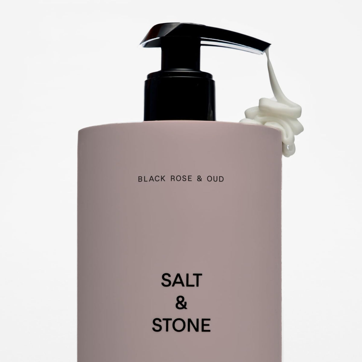 Salt & Stone bottle next to a everyday items for scale and travel-ready 15.2 fl oz size