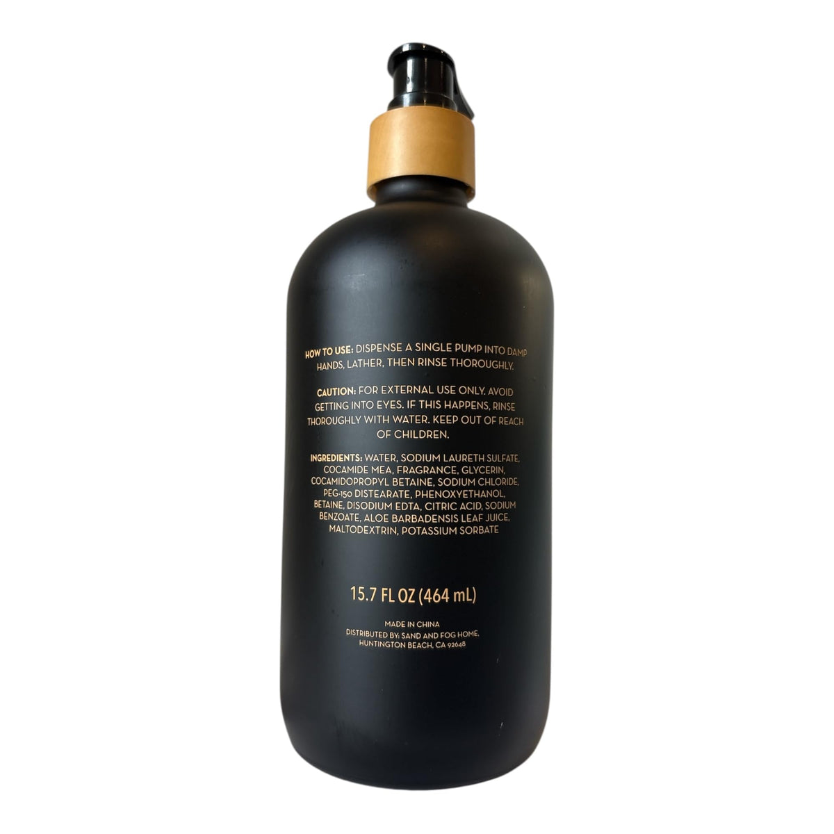 Sand + Fog Teakwood pump dispensing soap onto hand demonstrating moisturizing lather
