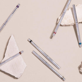 Sandstone Scandinavia pencil held in hand to show scale and travel-friendly size benefit