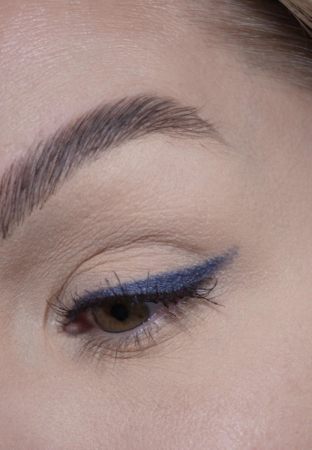 Sandstone Scandinavia denim pigment swatch on skin demonstrating metallic payoff
