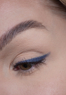 Sandstone Scandinavia denim pigment swatch on skin demonstrating metallic payoff