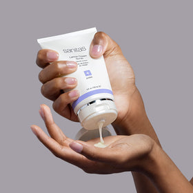 Sanitas lemon cream scrub in hand demonstrating creamy consistency and easy application