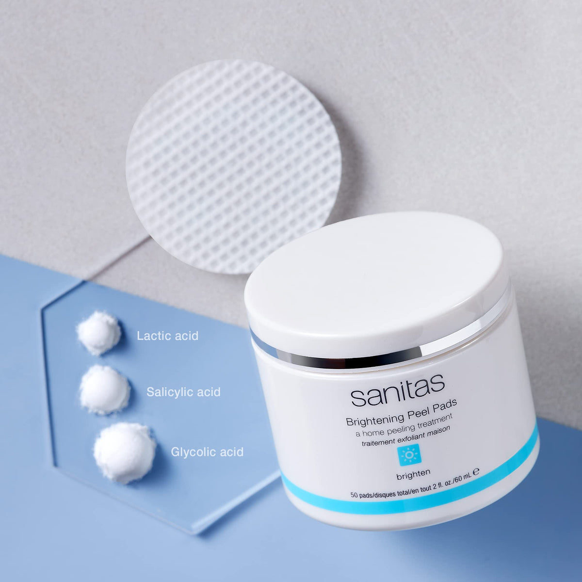 Close-up of a saturated Sanitas pad texture revealing gentle exfoliating solution