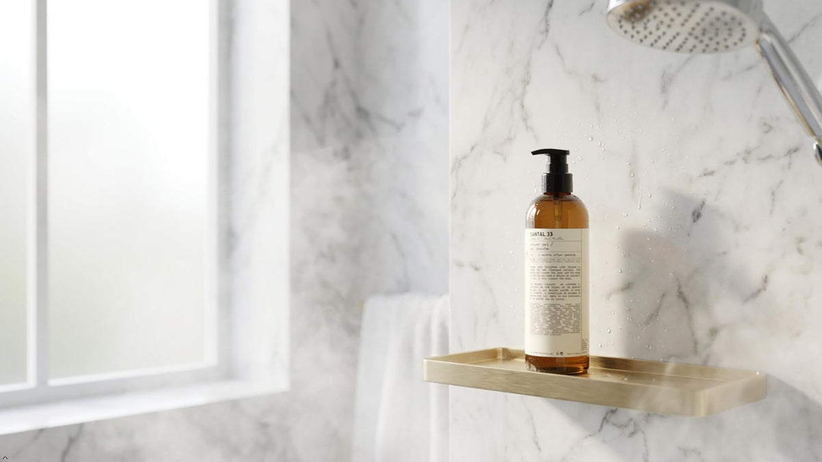 Santal 33 bottle placed on bathroom shelf conveying spa-like, elevated shower experience