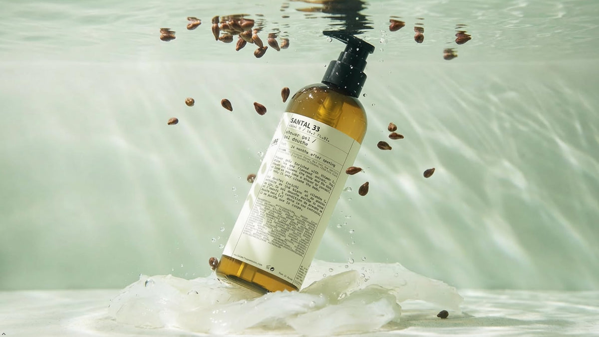 Santal 33 bottle held in hand to show 16.2 fl oz scale and travel-friendly size