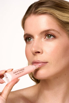 Sara Happ gloss on lips showing luminous shine and softened appearance
