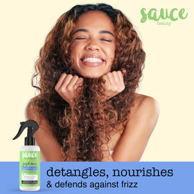 SAUCE BEAUTY mist being sprayed from bottle, demonstrating fine even application for detangling