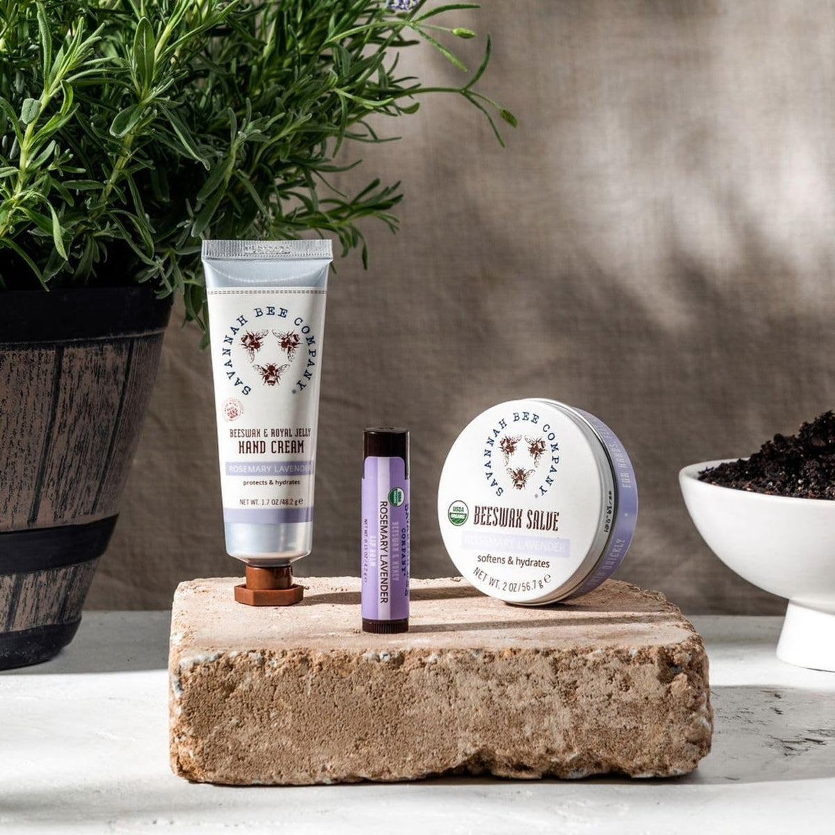 Savannah Bee Company lifestyle image using cream outdoors for on-the-go care