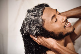 Scotch Porter being applied to damp hair showing improved definition and reduced frizz