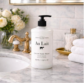 Scottish Fine Soaps Au Lait bottle beside kitchen sink illustrating large 25 fl oz supply for busy homes