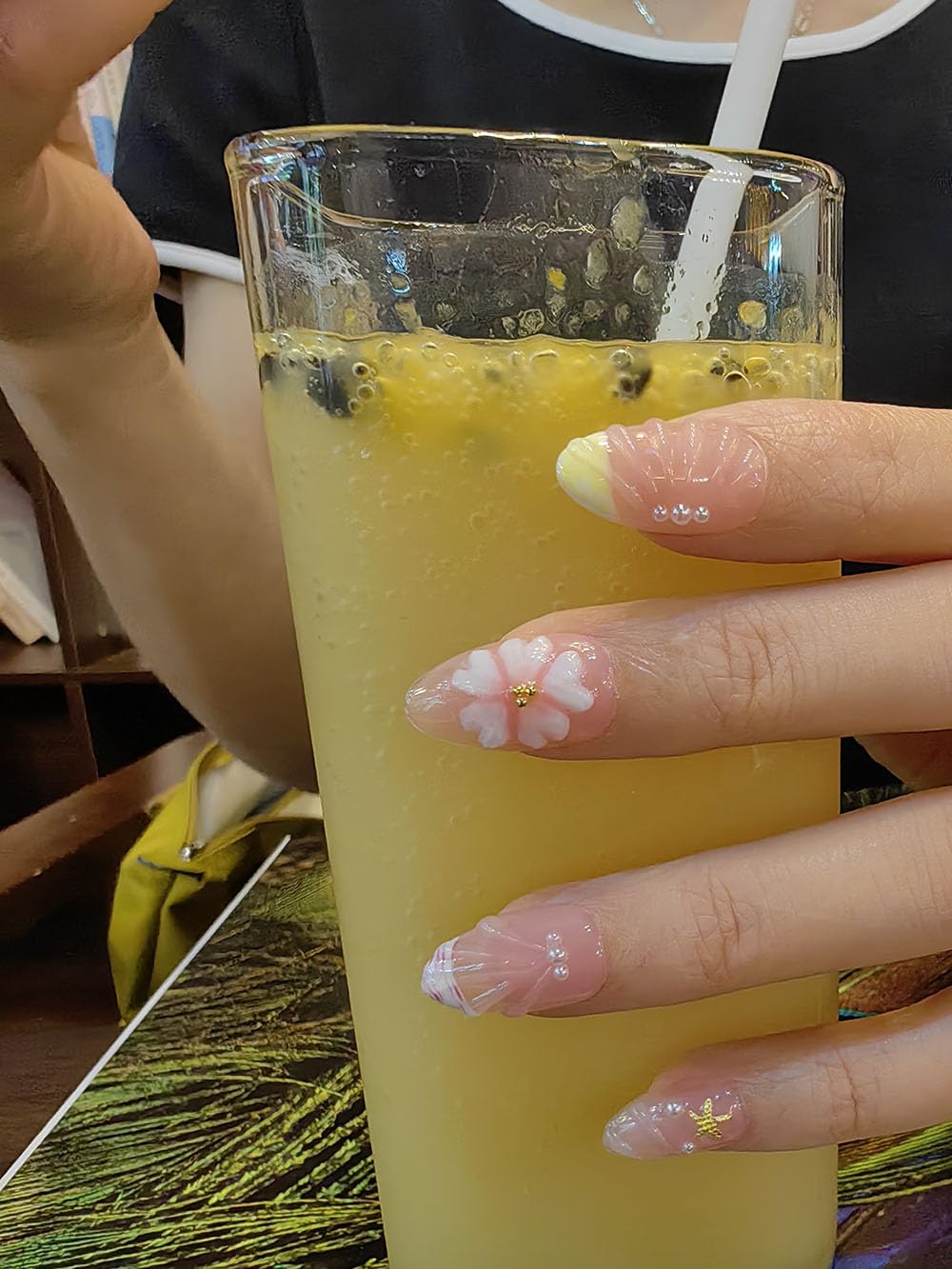 Seafish nails worn in a beach scene conveying seaside style and summer vibe
