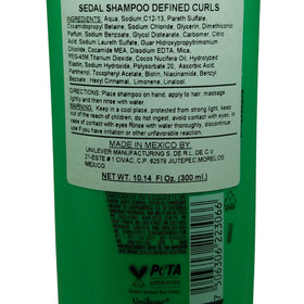Sedal Rizos Definidos in use on wet hair showcasing detangling and reduced frizz