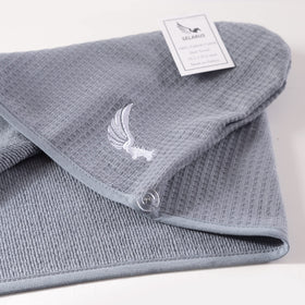 SELARUS towel flat lay with travel items showing convenient travel benefit